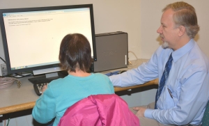 Photo: OCPL staff assisting patron with screen reader